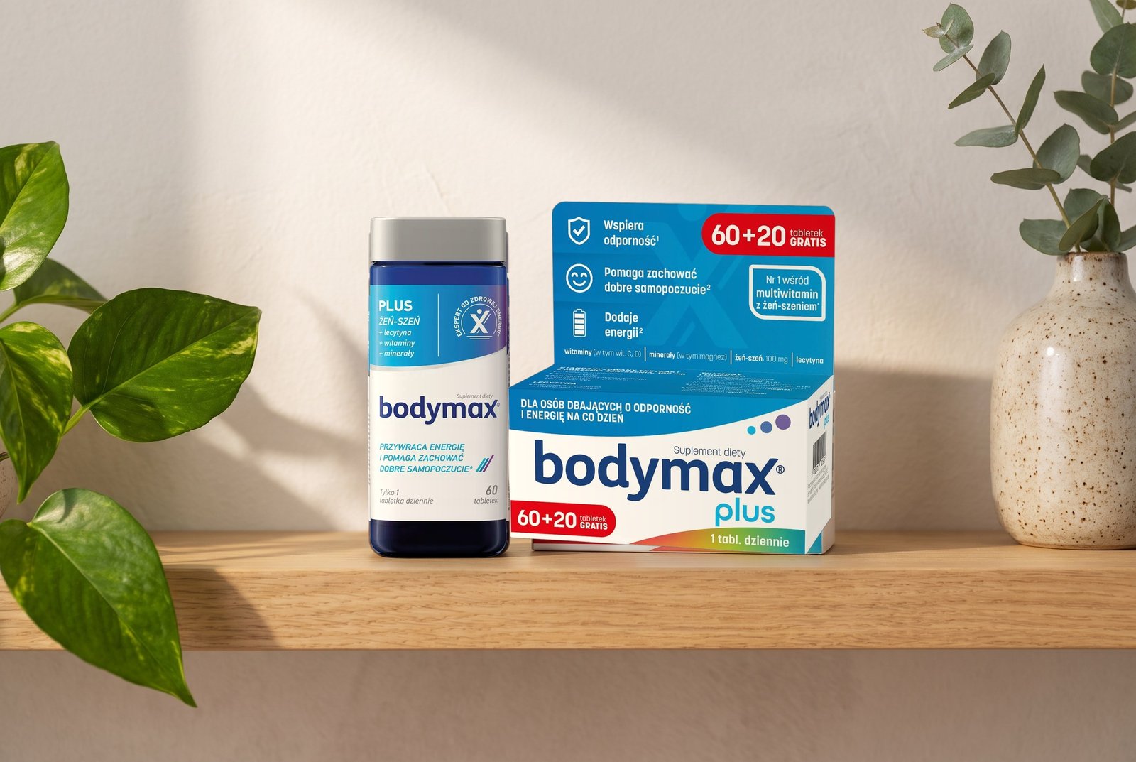 Słoik i pudełko suplementu Bodymax Plus z żeń-szeniem na drewnianej półce, zbliżenie w porannym świetle